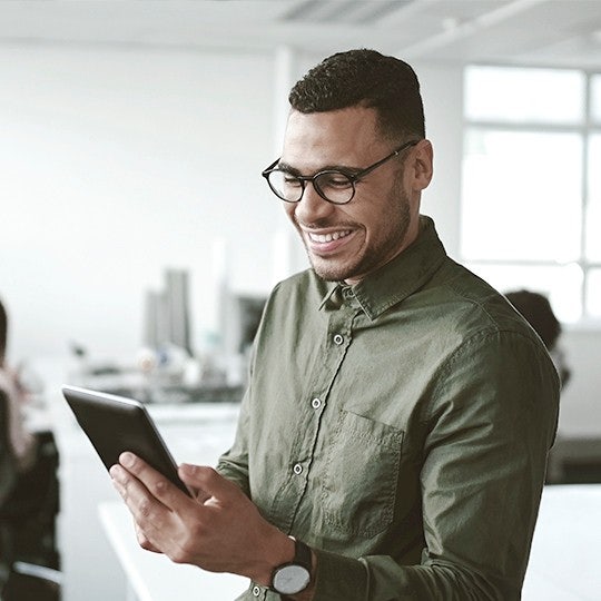 man looking into his tablet