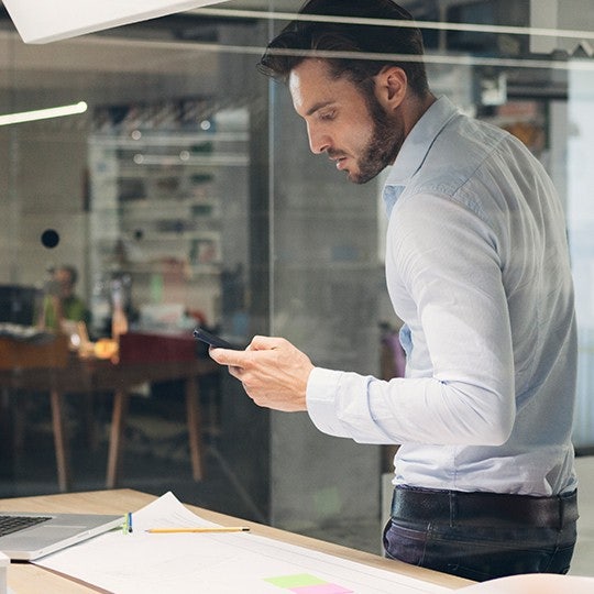 designer looking at his smartphone