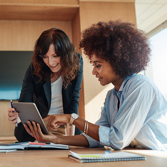 women working on a tablet