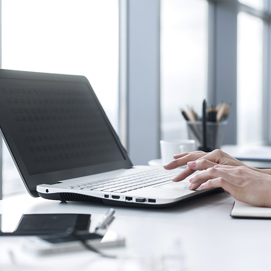 hands working with laptop