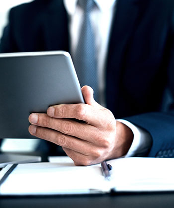 businessman checking a tablet