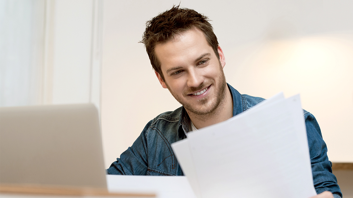 man looking to papers