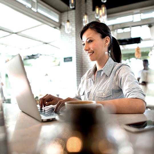 How to optimise invoice processing woman working on a laptop