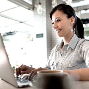 The benefits of automated invoice processing woman working on laptop